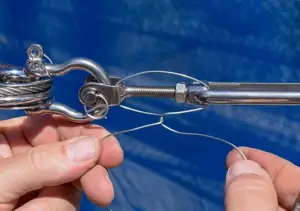 Feed Lock Wire through the Turnbuckle End and Body and twist together to tighten