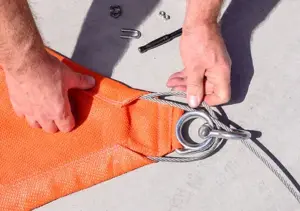 It should loop around the D Ring and Thimble