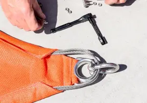 Both cable ends should be tucked into the pockets and looped around the D Ring and Thimble